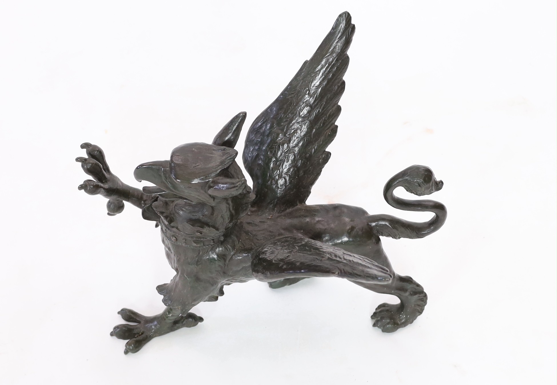 A 19th century bronze model of a griffon, length 58cm, height 45cm